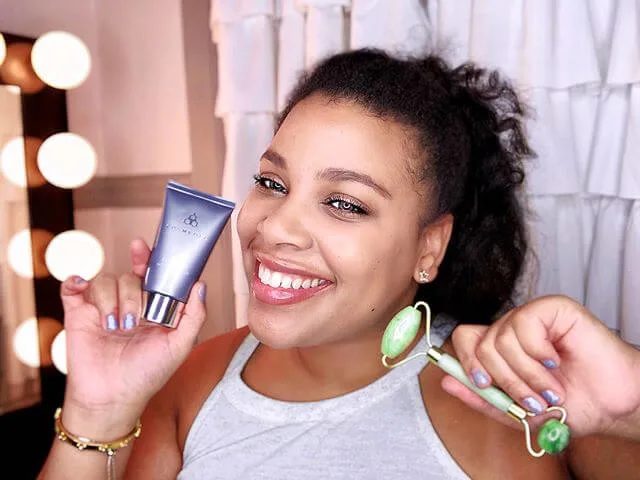 Creator poses with jade roller and COSMEDIX product