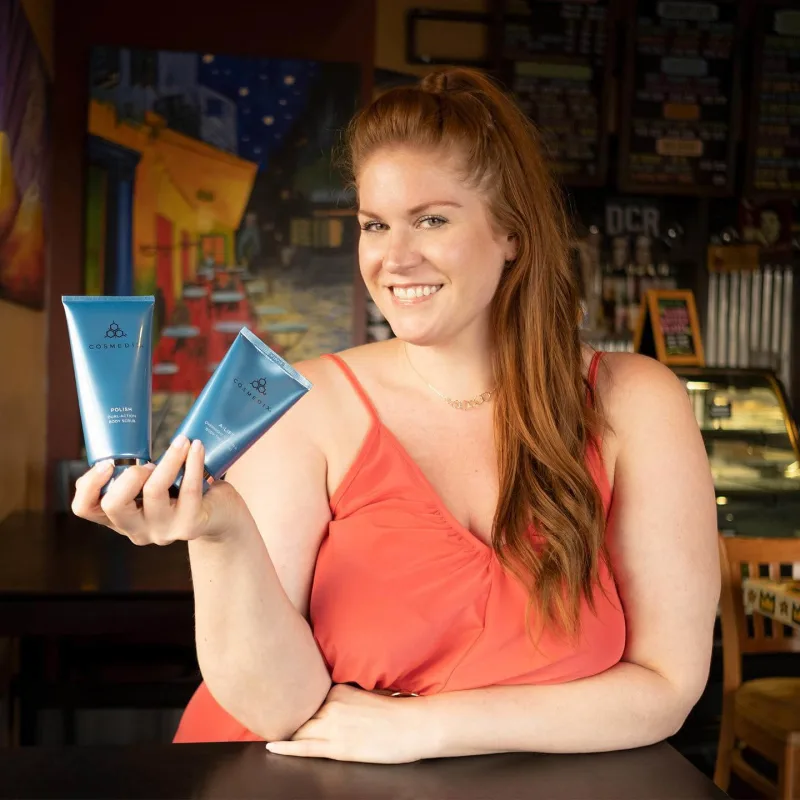 Creator with red hair poses with COSMEDIX product