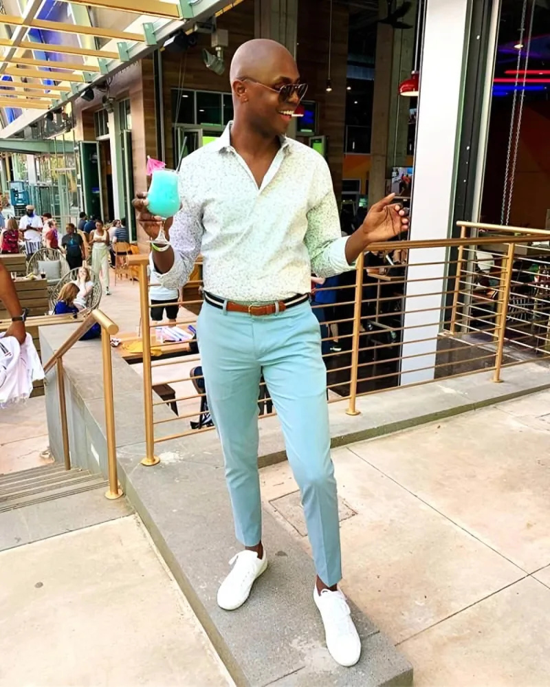 Man poses with a blue drink