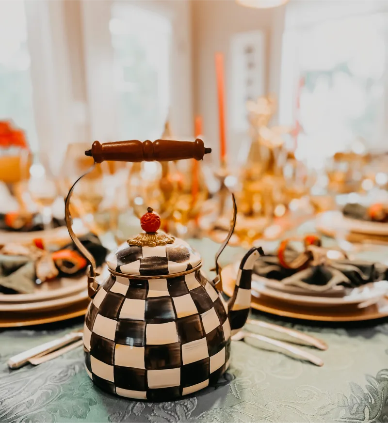 Sponsored MacKenzie Childs IG post featuring a checkerboard teapot