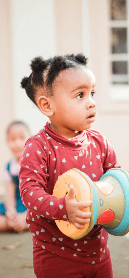 Baby in red onesie holds drum next to key campaign results