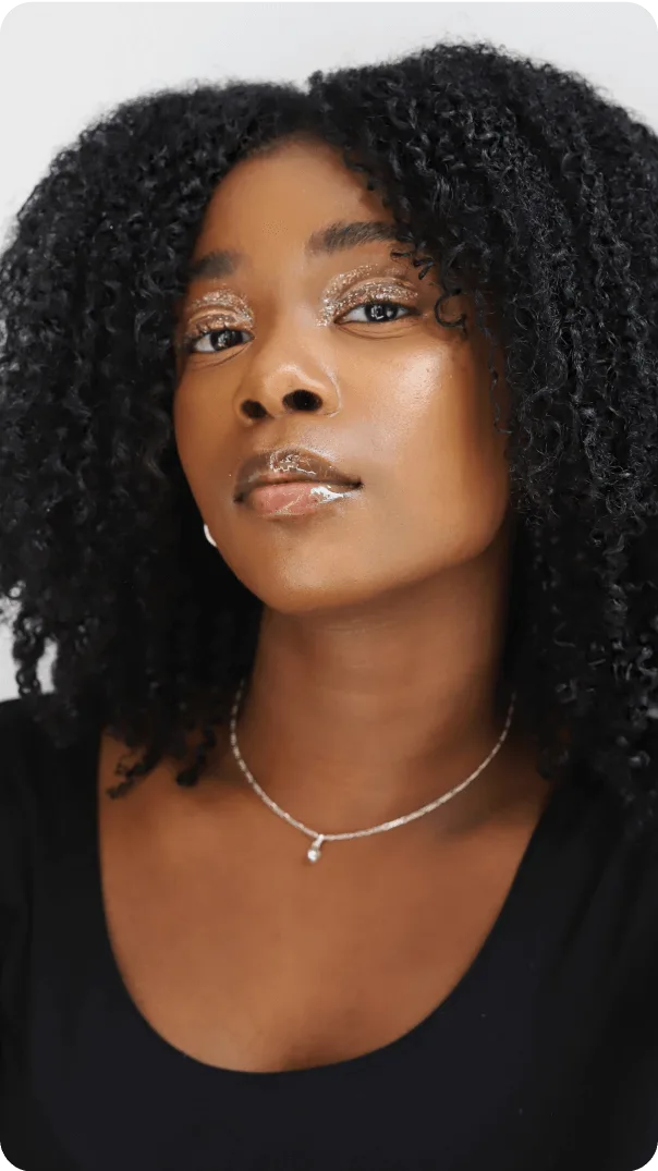 Second curly haired influencer stares into camera