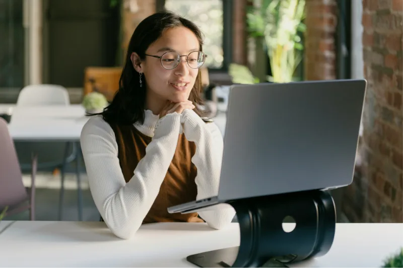 Key campaign results next to image of woman being interviewed on her laptop